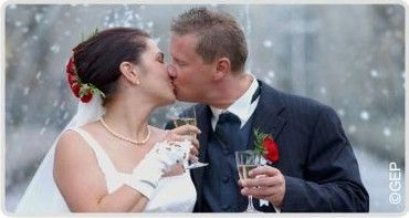 Brautpaar küsst sich im Schnee.