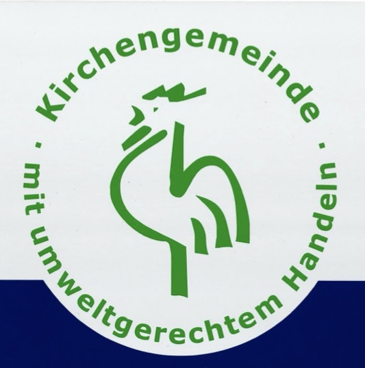 Gruppe lächelt und zeigt auf ein Schild an einer Wand.