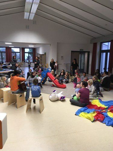Kinder spielen mit Rutsche und Bausteinen.